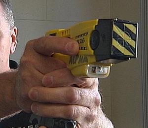 man pointing taser